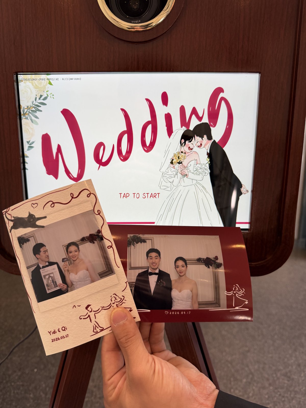 Two personalized wedding photo prints held in front of the Snapbooth screen